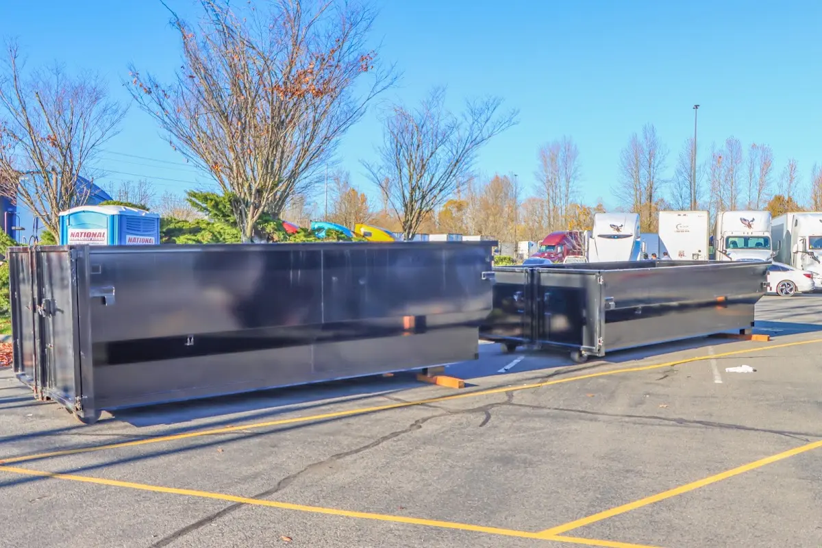 Professional dumpster rental service with roll-off container on residential driveway in Brandon